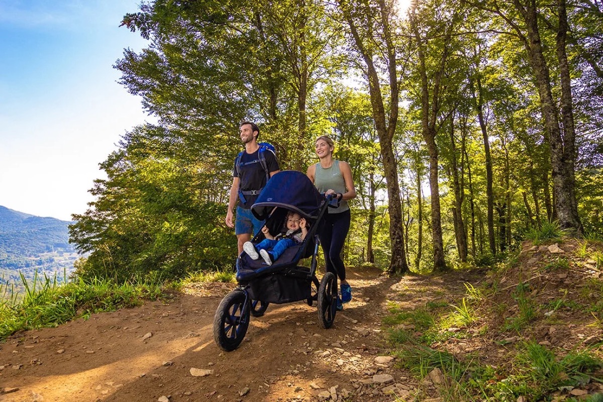 Caregiver jogging with the stroller over rocky terrain