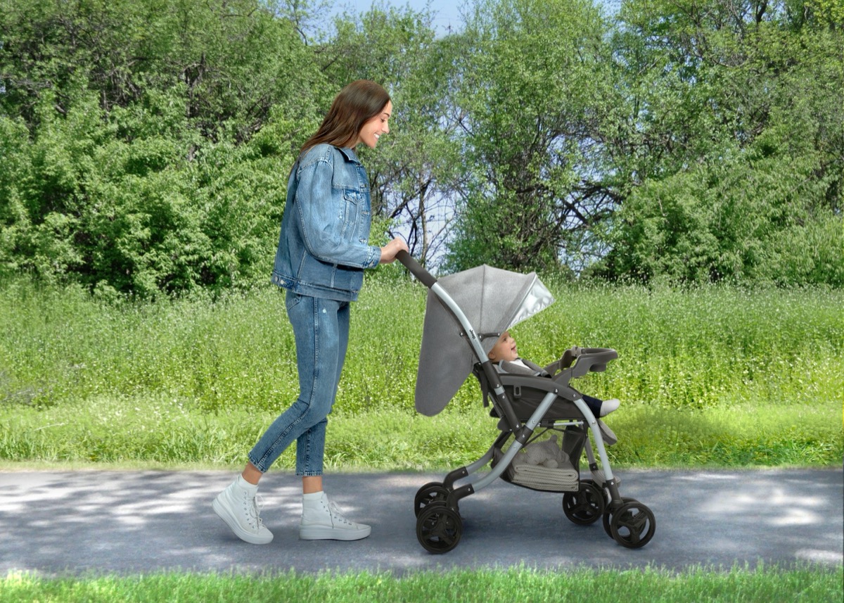 Official Delta Children lifestyle photo of the Jeep Unlimited Reversible Handle Stroller in the Grey Tweed colorway in an outdoor setting