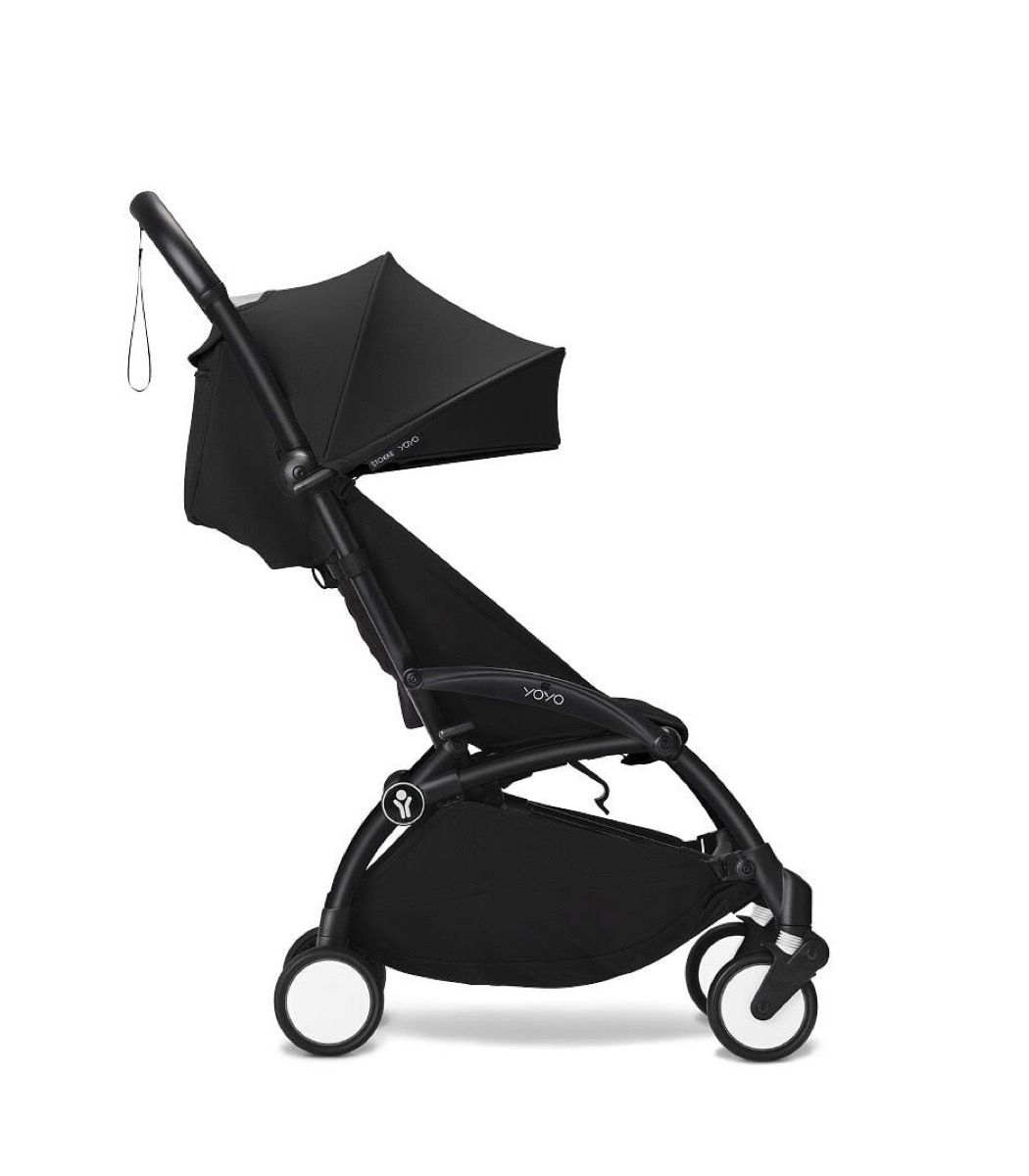 Same Black/Black YOYO3 6+ stroller in side profile with the canopy at mid-extension, showing the five-spoke compact wheels with white reflective hubs and the under-seat basket.